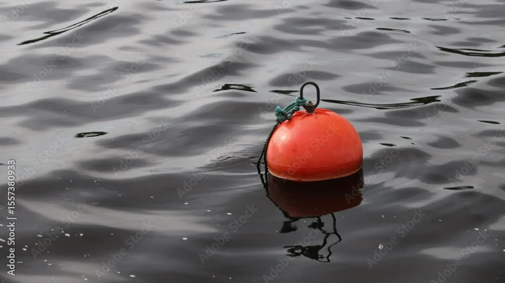 Poster a single red buoy floating on the surface of calm waters, perfect for use in scenes about sailing, n
