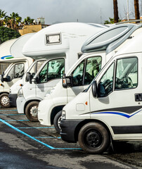 campers and motorhomes on asphatl parning, white auto caravan for  vacation travel