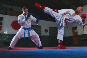 Teenage Boy Practicing Karate with His Father and Instructor