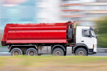 Red tanker truck driving fast