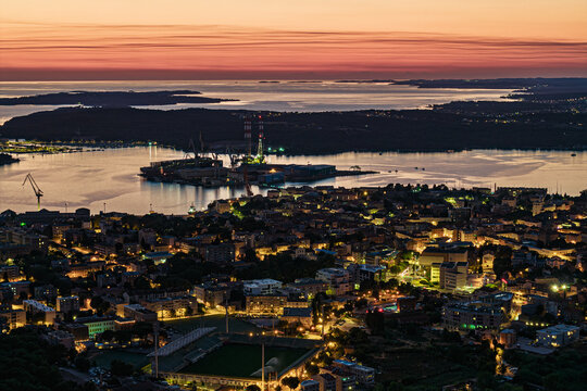 Night aerial view of the city of Pula and its coastline - Powered by Adobe