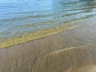 Soft waves on sand beach. 