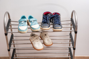 dirty shoes of all family members are on the shelf. Sorting things and decluttering