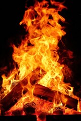 Close-up of mesmerizing bright fire with orange and yellow flames Long tongues flame burning
