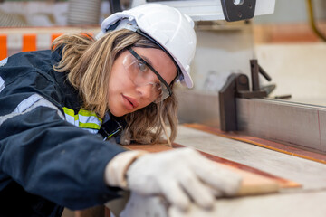 Female carpenter factory worker  at manufacturing lines in wooden warehouse storage plant, wood...