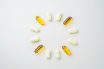 Clock made of pills capsules, pills form a circle, omega, vitamins, Cod liver oil, supplements