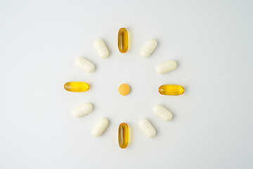 Clock made of pills capsules, pills form a circle, omega, vitamins, Cod liver oil, supplements