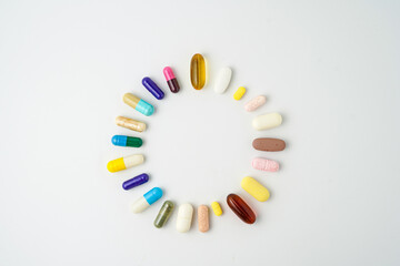 Clock made of pills capsules, pills form a circle, omega, vitamins, Cod liver oil, supplements