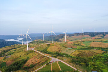 Aerial view of powerful Wind turbine farm for energy production on beautiful cloudy sky at...