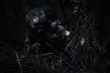 Army sniper during the military operation, dark process