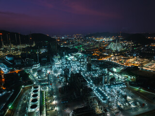 Aerial view oil and gas storage tank, oil refinery factory plant at night form industry zone, Oil...