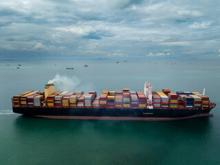 logistic cargo container ship sailing in sea to import export goods and distributing products to...