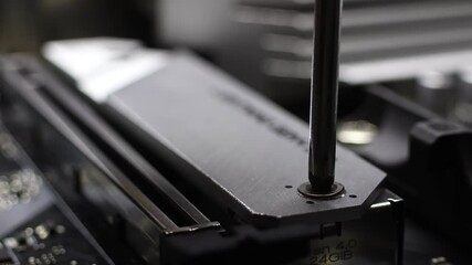 Installation process of NVME SSD drive in M.2 2280 slot on motherboard. Closeup view of desktop PC assembly. Concept of hardware upgrade. - Powered by Adobe