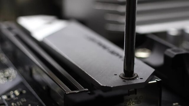 Installation process of NVME SSD drive in M.2 2280 slot on motherboard. Closeup view of desktop PC assembly. Concept of hardware upgrade.