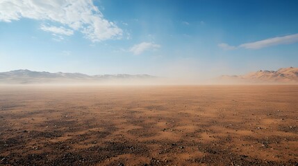 The vast expanse of sand and gravel on the gobi desert is swept by the wind, lifting dust into the air