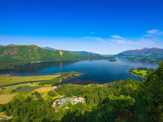 Scenic view of Derwentwater lake and surrounding mountains from Surprise View on a sunny day (Keswick, England, United Kingdom)