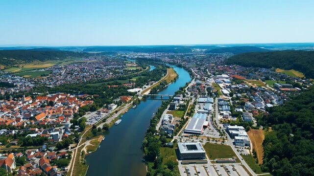 Befreiungshalle in Kelheim, Germany, captured from a drone on a bright summer day. This impressive circular monument stands above the Danube, surrounded by lush green landscape