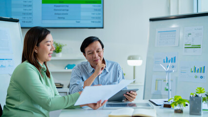 Creative professionals discussing net zero strategy in office focused on renewable energy...
