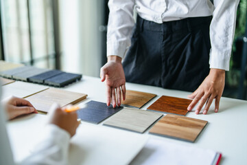 Interior designer discussing wood laminate materials in modern office