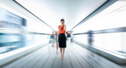 Woman using phone and walking on footbridge