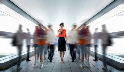 Woman using phone and walking on footbridge