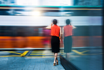 Woman using phone and standing on the street