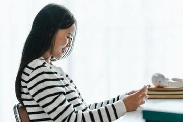 Woman concentration focus online gaming with smartphone