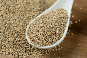 Natural white quinoa in a spoon macro