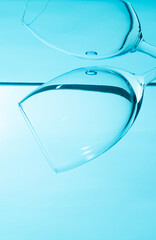 Glass in water isolated on blue background