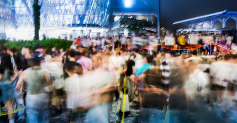 Blur of crowd people queuing up and waiting