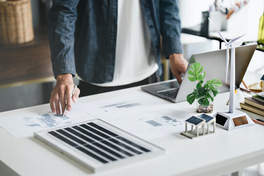 Business eco Alternative, sustainable electricity, people creating ideas working on green energy in eco friendly office