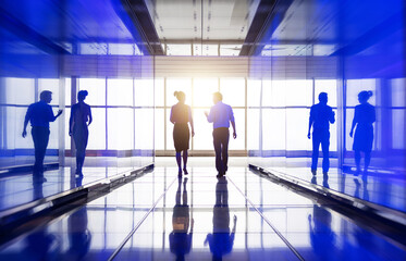 Business people walking and talking in the hallway