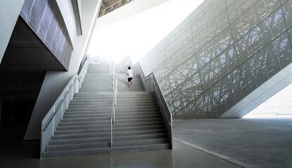 The boy running and exercising on the stairs