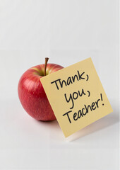 Red apple with thank you note for teacher on white background. World Teachers' Day