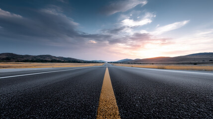Naklejka premium Empty City Road Facing Downtown Skyline During Sunrise 