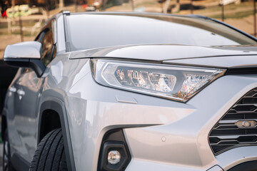 Close-up of car headlights of a new car. Automotive leasing and insurance. Automotive industry. The...