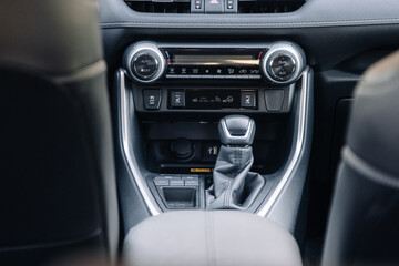 A close-up of the gearbox of a modern, new car. Concept of stylish design, shopping, and car parts.