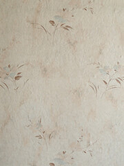 A vintage beige wallpaper with a delicate, repeating floral pattern, perfect for backgrounds.