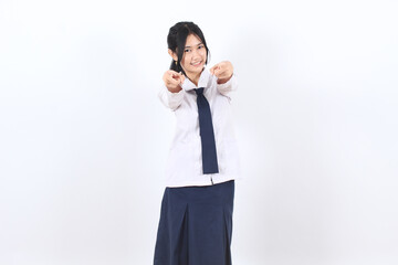 Asian teenage girl with long hair wearing school uniform pointing to camera