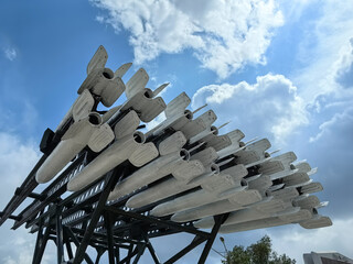 Military rockets on display, set against a beautiful blue sky and fluffy white clouds. Photographed...