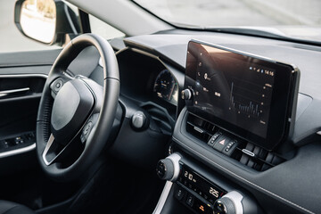 Close-up of a car steering wheel in a modern new car. The interior of a stylish new car. Concept of...