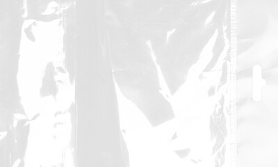 plastic transparent cellophane bag on white background. The texture looks blank and shiny. The plastic surface is wrinkly and tattered making abstract pattern