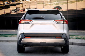 Close-up of a gray, new modern car outdoors. Concept of renting or buying a new car and modern...