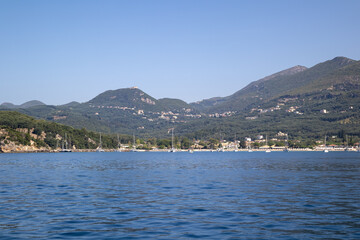 Picturesque Coastal Town and Marina Nestled Against Green Mountains