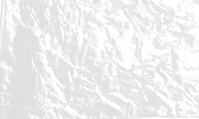 plastic transparent cellophane bag on white background. The texture looks blank and shiny. The plastic surface is wrinkly and tattered making abstract pattern