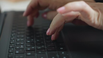 Close up of woman typing on laptop keyboard with fingers having pink painted nails, captured in soft blur background, emphasizing motion and focus during digital work environment indoors - Powered by Adobe