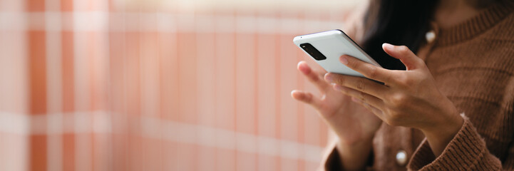 Woman using smartphone online searching on internet