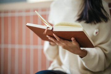 Asian University student read a book at university outdoor