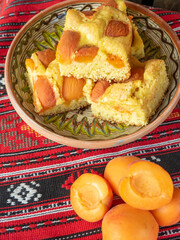 homemade apricot sponge cake on romanian traditional red cloth