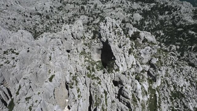 A drone flies over the fantastic karst cliffs of the Tresteni vrh plateau